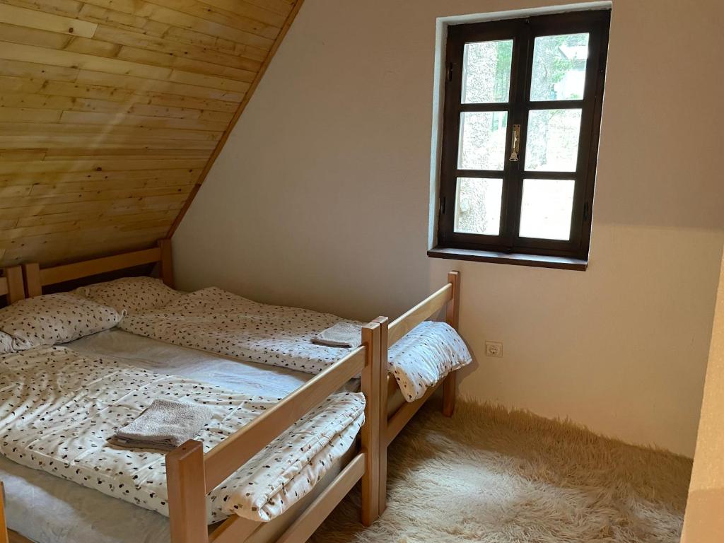 two bunk beds in a room with a window at Moonica Rujiste in Mostar