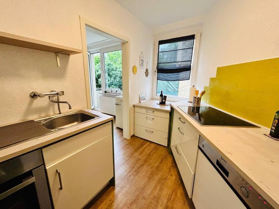 a kitchen with a sink and a counter top at Schickes Messe Appartement mitten in Essen in Essen