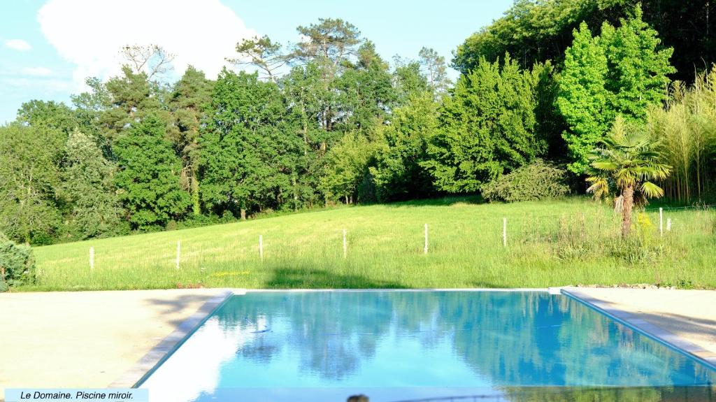 a swimming pool in the middle of a field at Domaine du Champ de l'Hoste in Larzac