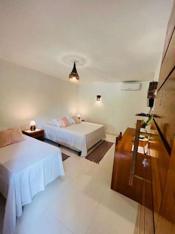 Uma cama ou camas num quarto em Pousada Pandoro