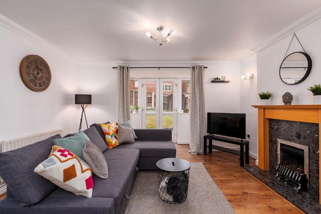 a living room with a couch and a fireplace at Hills Close in Mexborough