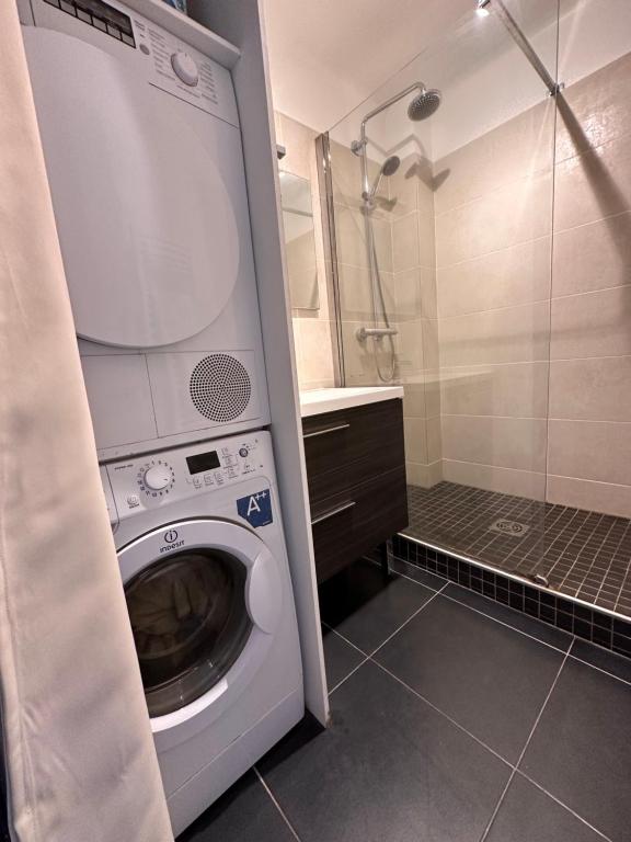 een wasmachine in een badkamer met een douche bij Le soulier de notre dame in Marseille