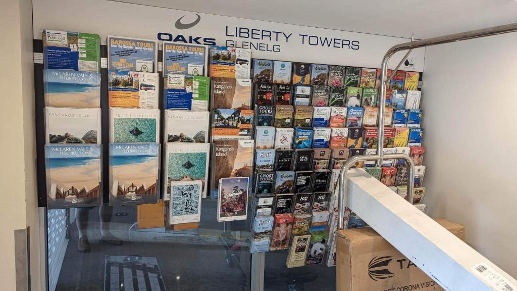 a display window of a library with books and posters at Glenelg resort style beachside apartment in Glenelg