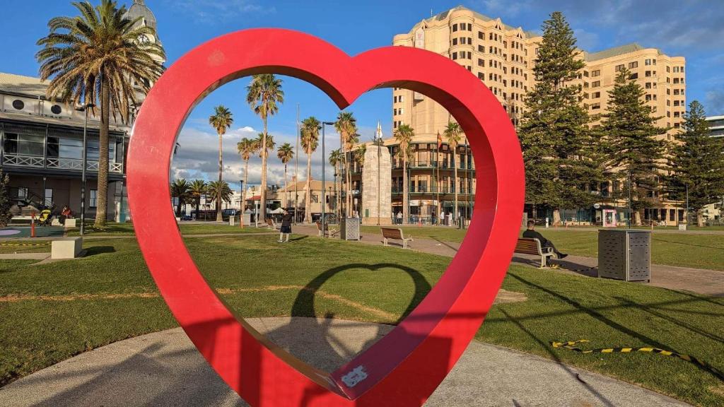 a large red heart sculpture in a park at Glenelg resort style beachside apartment in Glenelg
