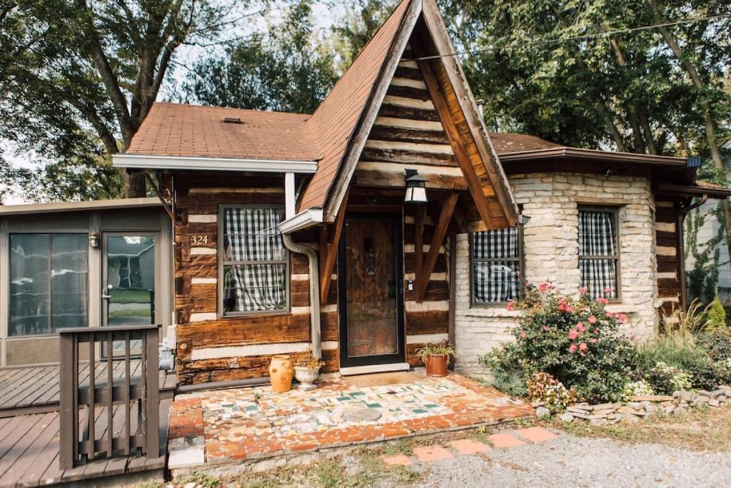 a small log cabin with a front door at Downtown-Urban Cabin Unique Stay in Murfreesboro