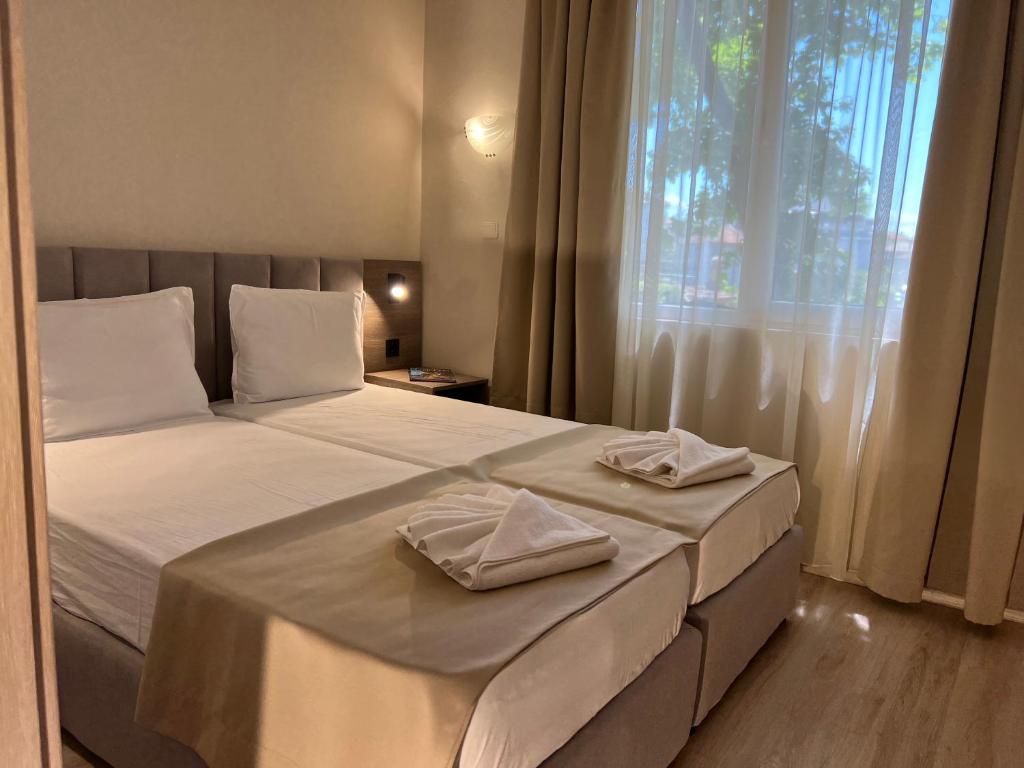 Postel nebo postele na pokoji v ubytování Lotos Apartments