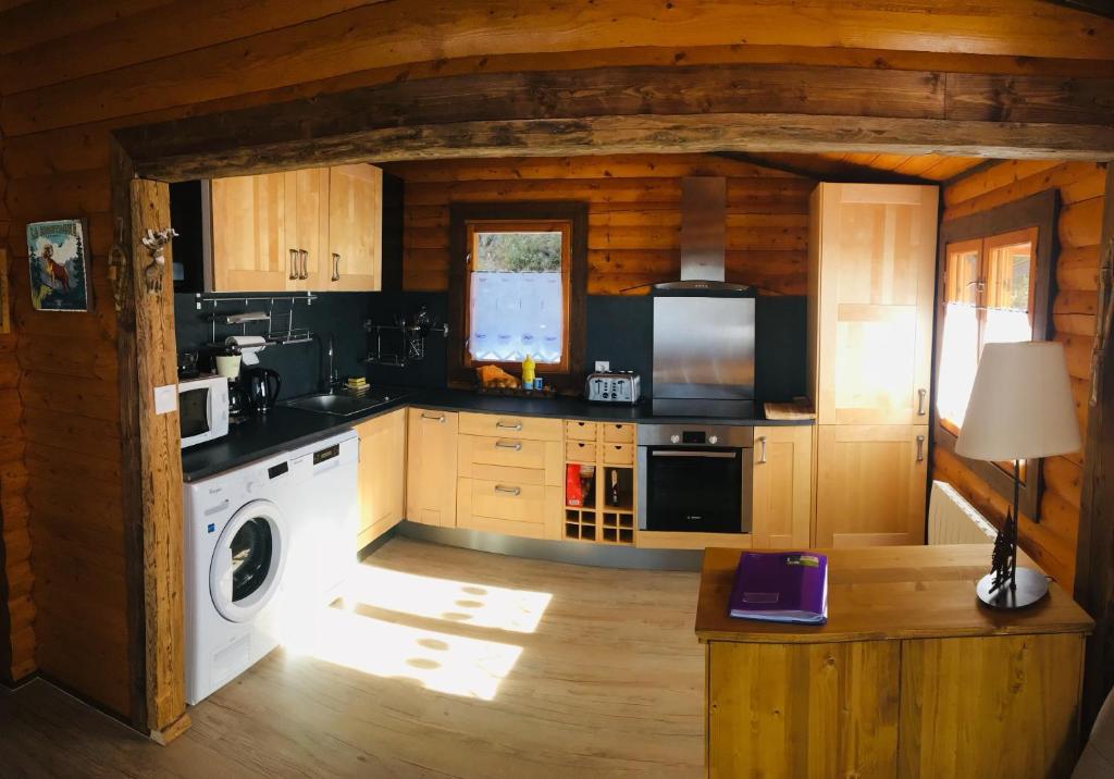 a kitchen in a log cabin with a stove at El Chalet du Père Castor in Bolquere Pyrenees 2000