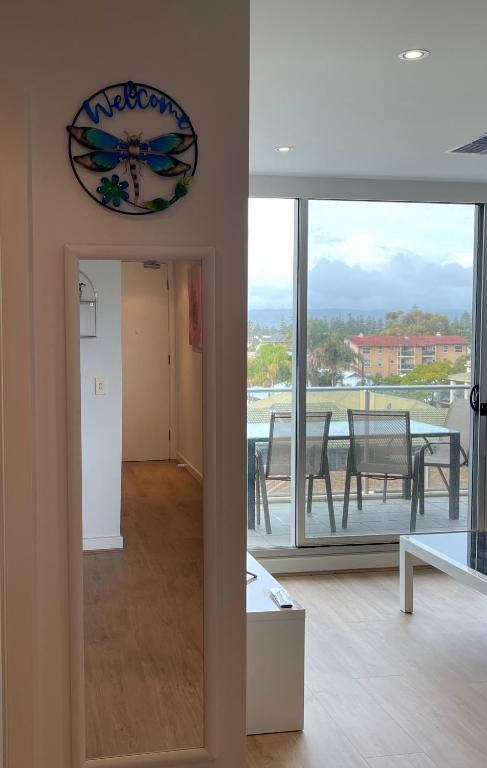 a view of a living room with a view of a dining room at Glenelg resort style beachside apartment in Glenelg