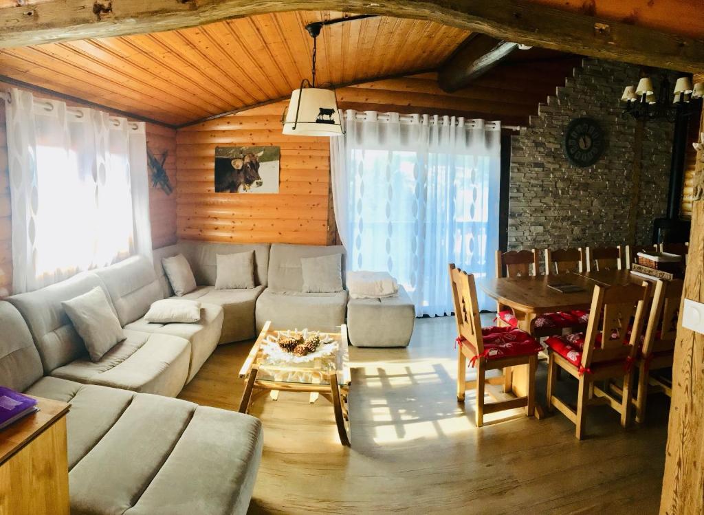 a living room with a couch and a table at El Chalet du Père Castor in Bolquere Pyrenees 2000