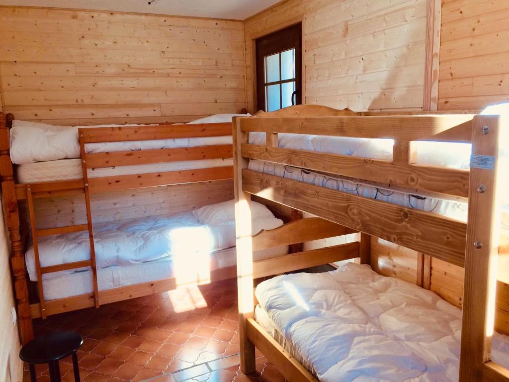 a room with two bunk beds in a cabin at El Chalet du Père Castor in Bolquere Pyrenees 2000