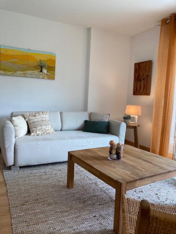 a living room with a couch and a coffee table at Le GLAZ * Grande plage & commerces à pied * Jardin in Carnac