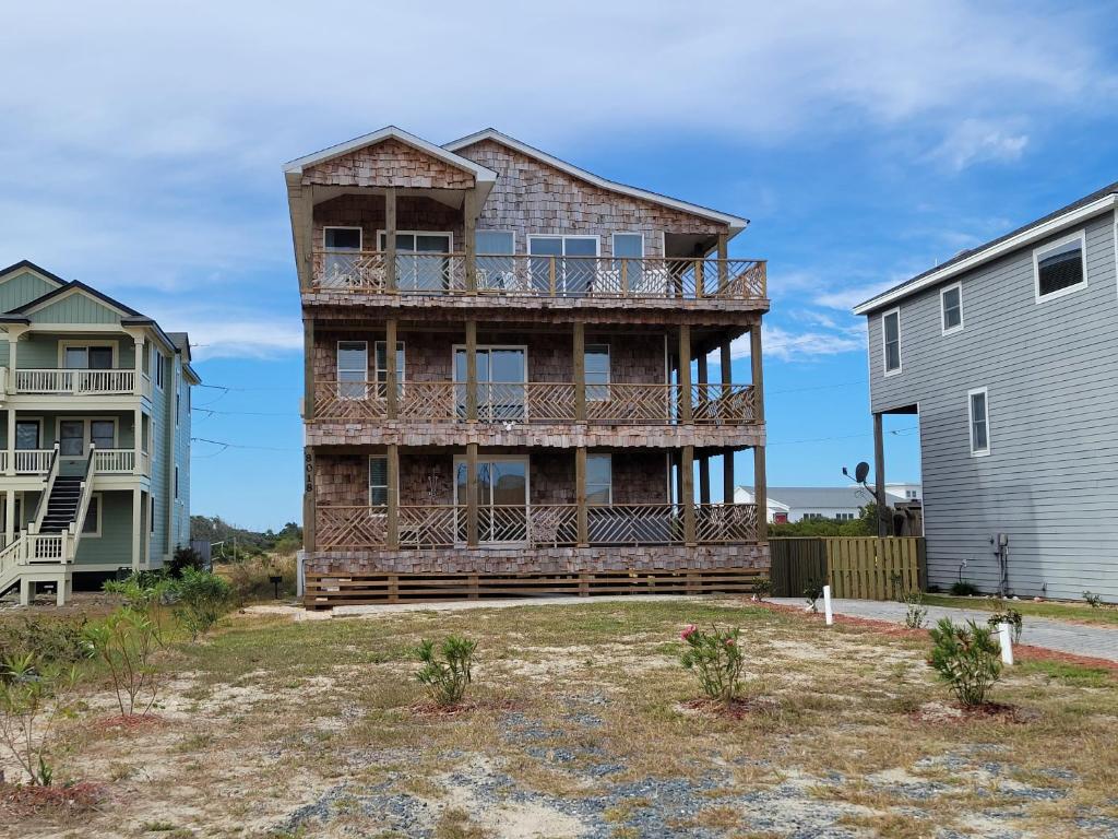 a house on the beach with two buildings at 8018 Beach Rd, Semi-Oceanfront, Pool/Hot Tub in Nags Head