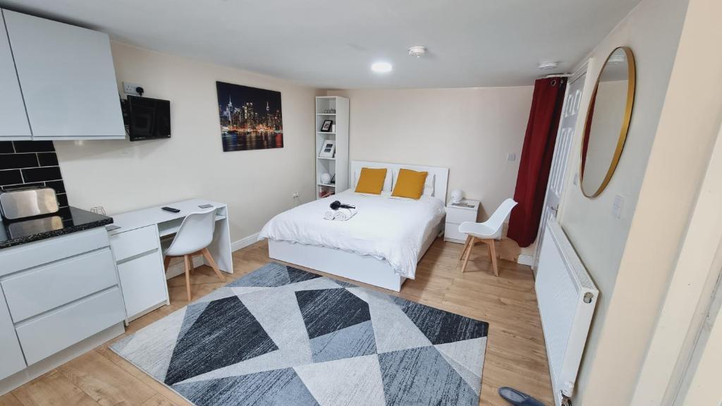 een kleine slaapkamer met een bed en een bureau bij Lovely studio-flat with free parking, free WiFi. in Leeds