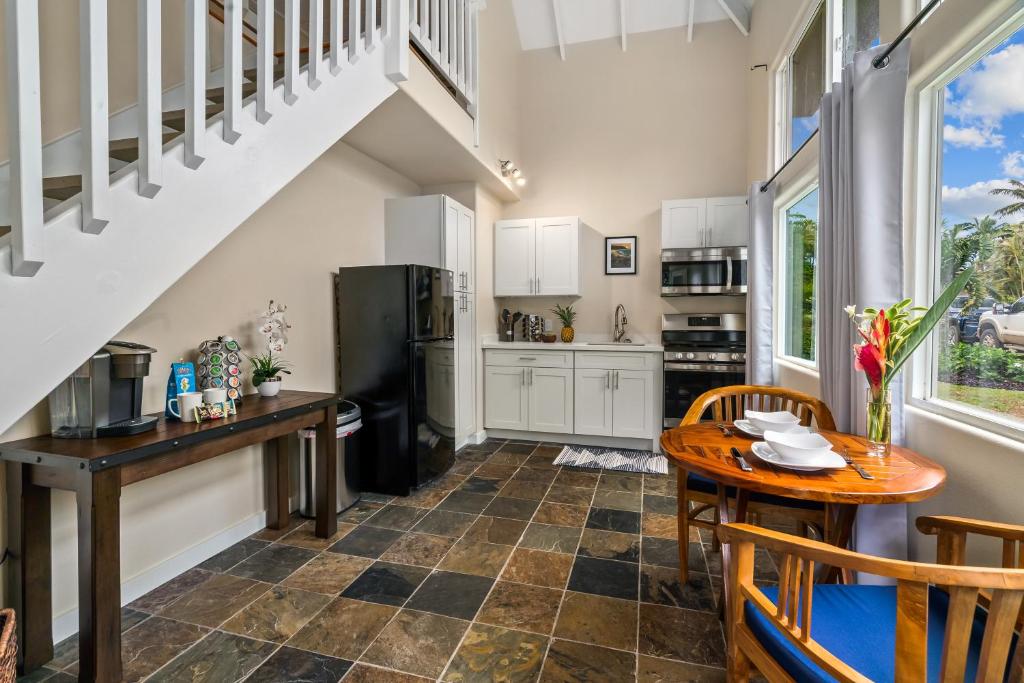 a kitchen with a staircase and a table and chairs at 3982S Kalakaua Gorgeous Princevile Studio in Princeville