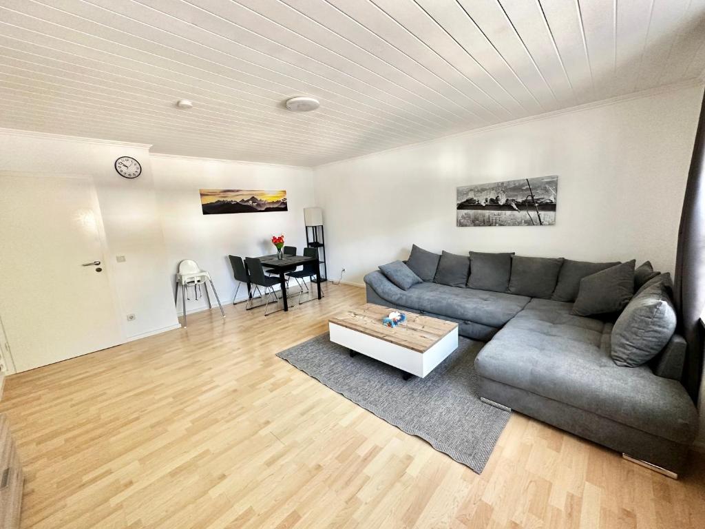 a living room with a couch and a table at BocholtApartments in Bocholt