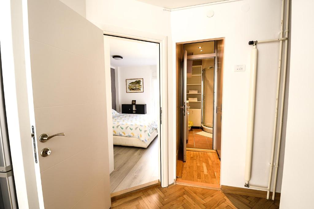 a door leading into a bedroom with a bed at Apartment Petra 073 in Belgrade