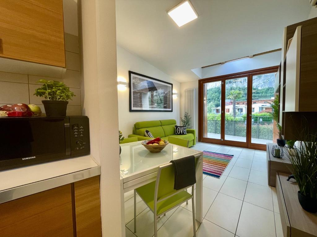 a kitchen with a table and a microwave oven at Outdooredo Garda Torbole in Nago-Torbole
