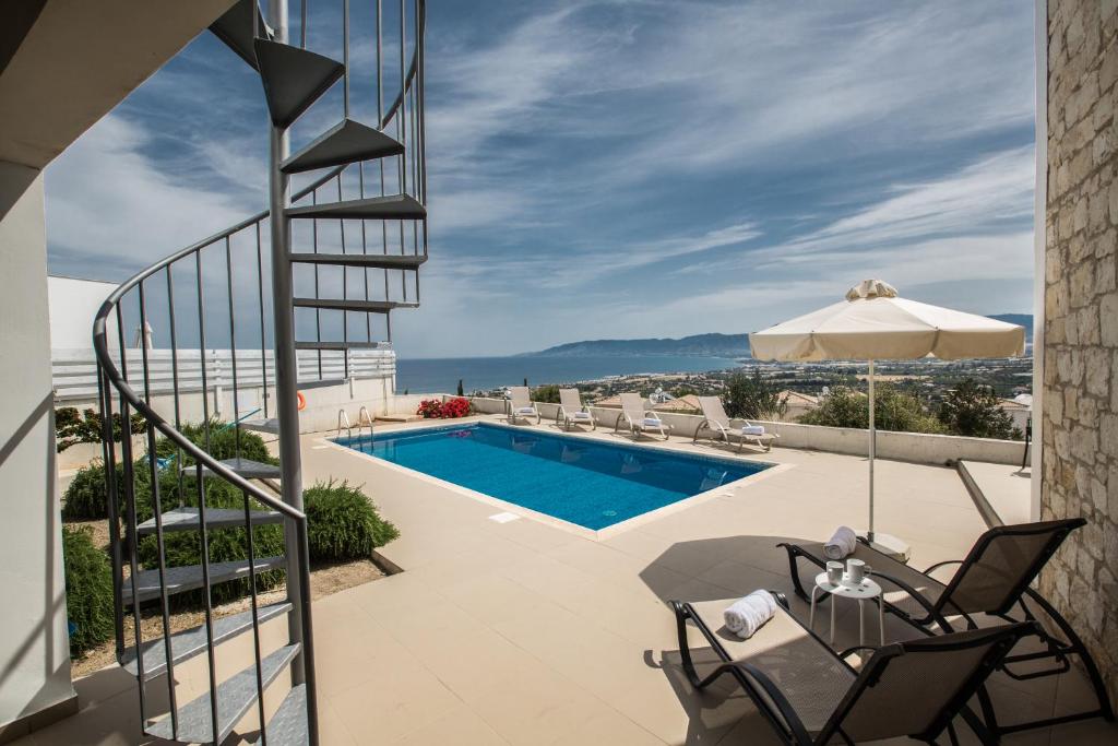 a view from the balcony of a house with a swimming pool at Esprit Villa 20 in Polis Chrysochous