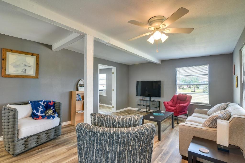 a living room with two chairs and a ceiling fan at Pet-Friendly Texas Escape with Deck and Fenced-In Yard in Freeport