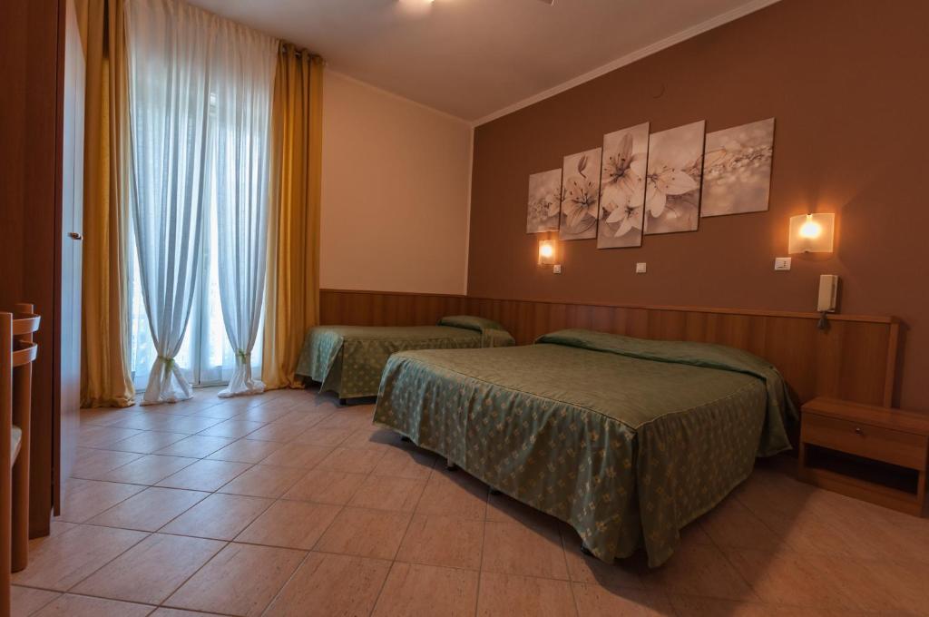 Postel nebo postele na pokoji v ubytování Hotel Orsini