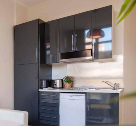 A kitchen or kitchenette at Apartamentos Uncibay Premium