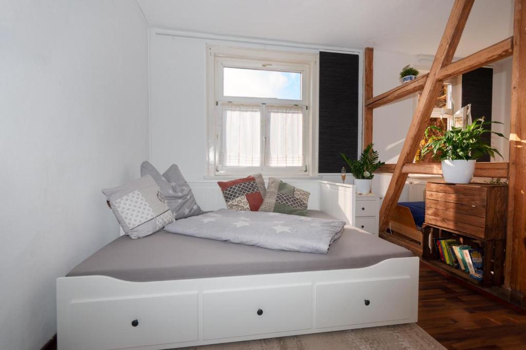 a white bed in a room with a window at Temporary Living - Rest and Relax in Eisenach