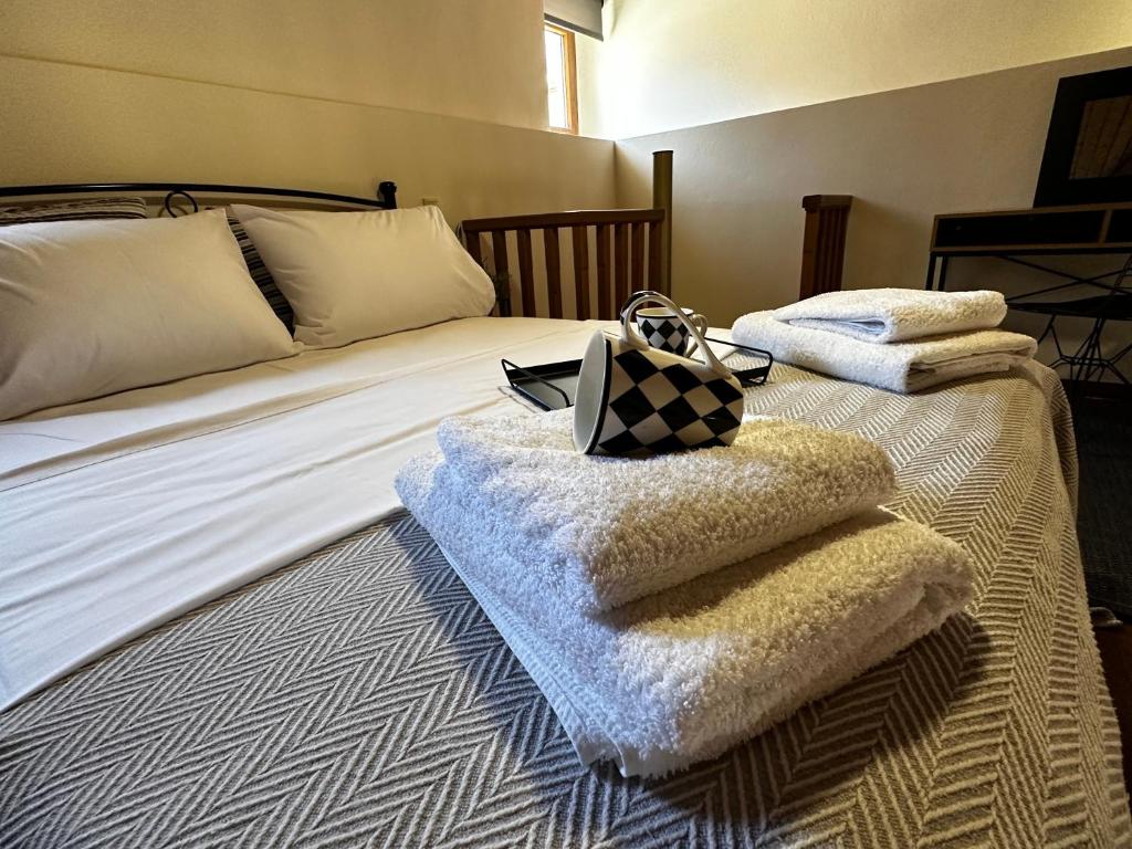 a bedroom with a bed with towels on it at Maisonette Nineta in Heraklio