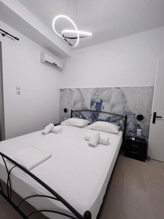 a bedroom with a large white bed with white pillows at Mano’s House Preveza 2 in Preveza