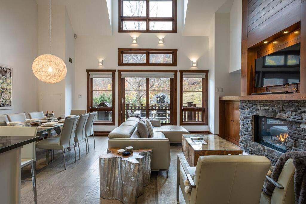 a living room with a couch and a fireplace at Tremblant Prestige - Étoile 1500-5 in Mont-Tremblant