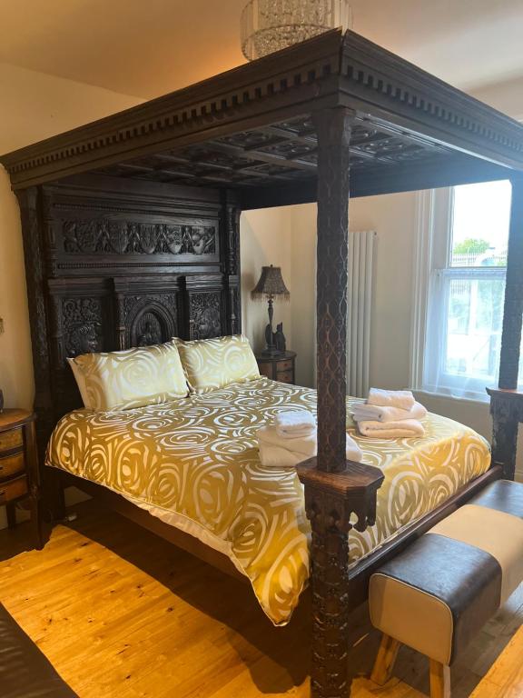 a bedroom with a large bed with a canopy at Abbey Canterbury in Kent