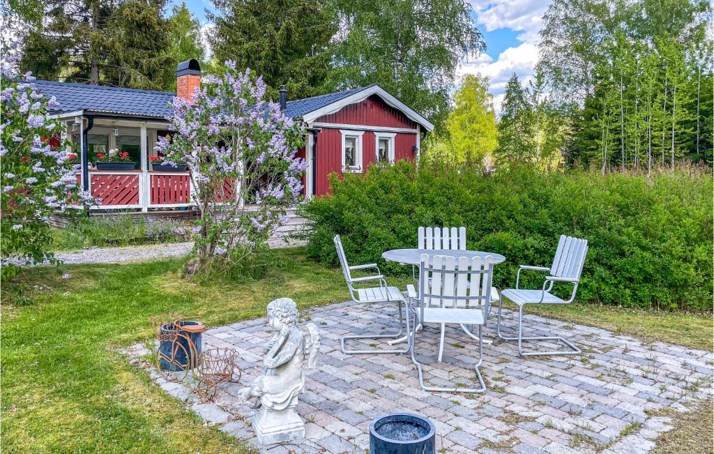 a patio with a table and chairs in a yard at Lovely Home In Sala With Kitchen in Sala