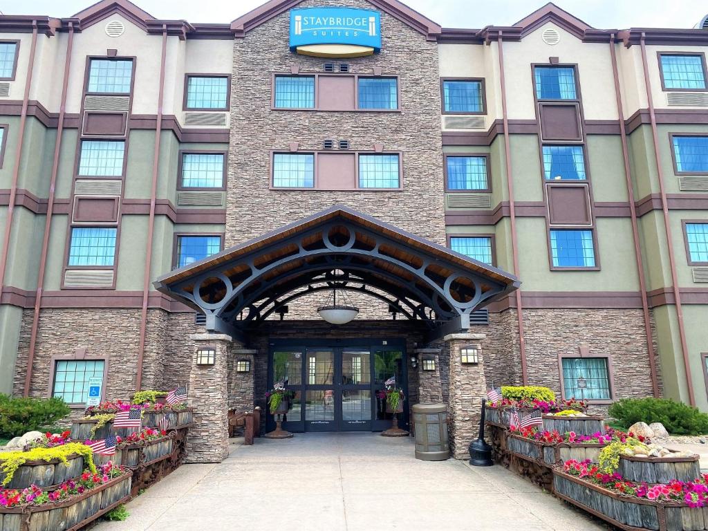 a hotel entrance with people standing in front of it at Staybridge Suites Great Falls, an IHG Hotel in Great Falls