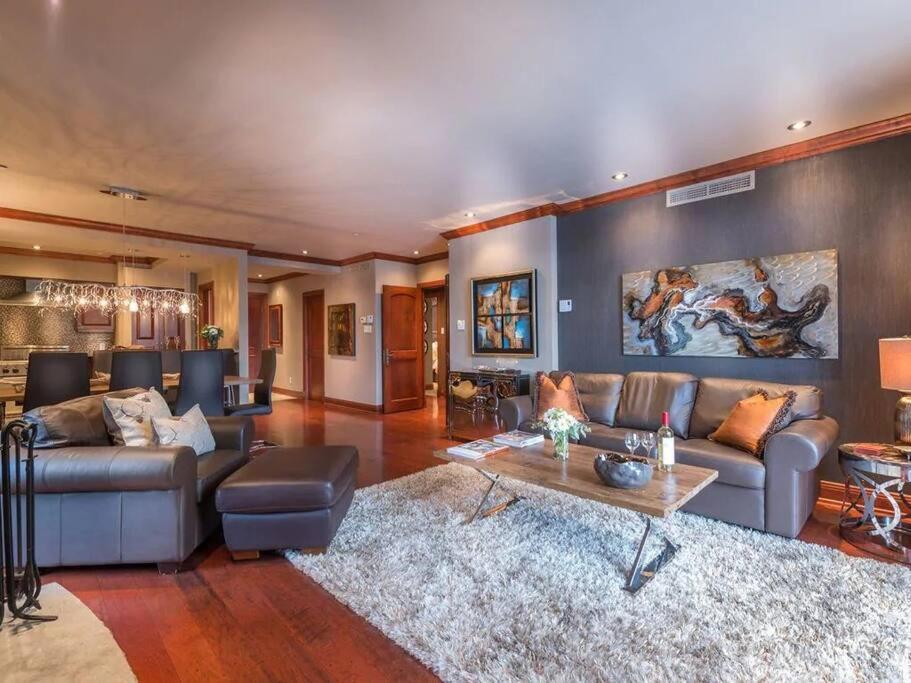 a large living room with a couch and a table at Bondurant 95-8 / COZY and LUXURIOUS 3 bedroom in Mont-Tremblant