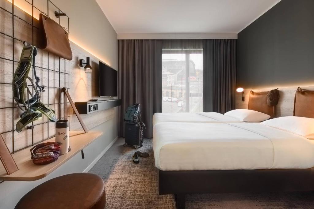 Postel nebo postele na pokoji v ubytování Moxy Dresden Neustadt