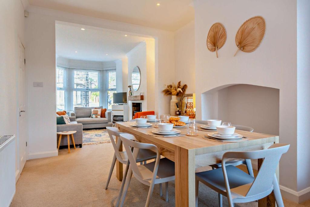 a dining room and living room with a table and chairs at 3-bedroom home with free parking&flexible bed configuration in Harrogate