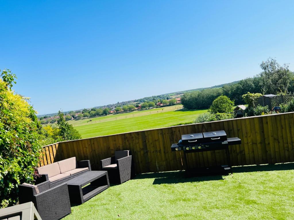 a backyard with a fence and a table and chairs at Fox House in Rotherham