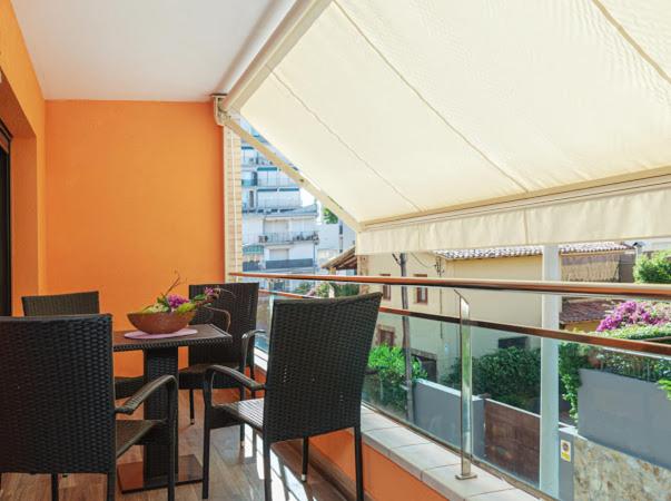 a balcony with chairs and a table on a building at Parrot’s House in Lloret de Mar