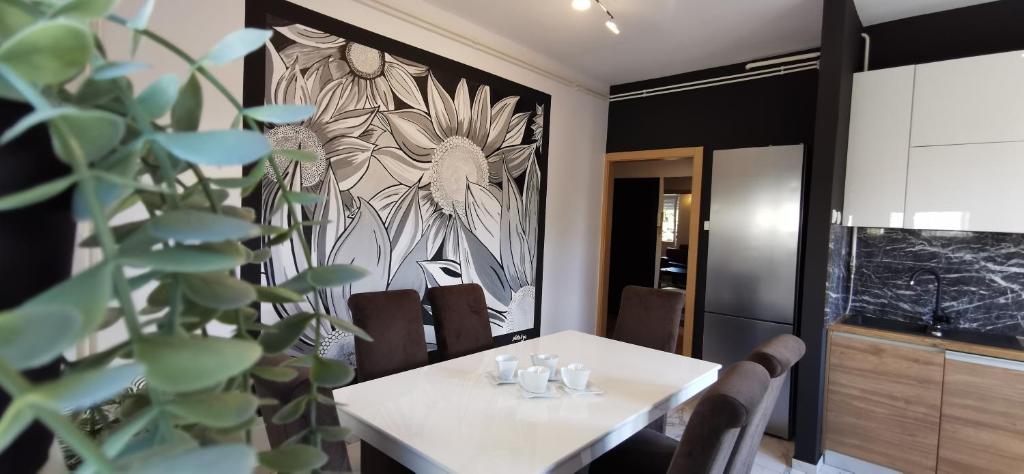 une salle à manger avec une table et une peinture d'un oiseau dans l'établissement Apartman Wolf, à Varaždin
