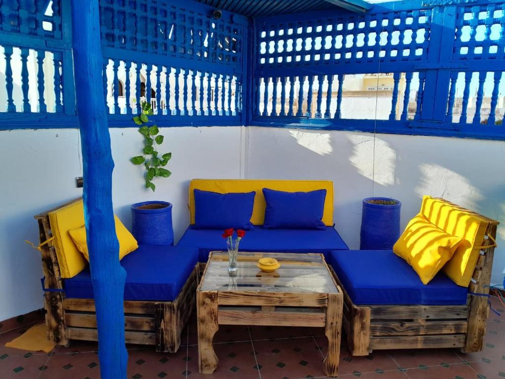 a blue couch and a table in a room at Wave Mogador in Essaouira