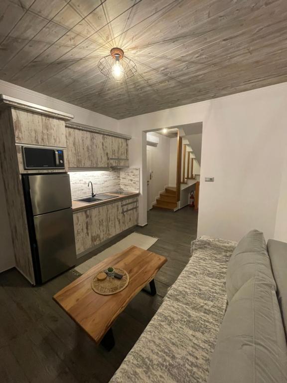 a living room with a couch and a table at emiliapartments in Skála Sikiás