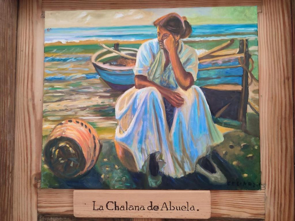 una pintura de una mujer hablando por celular en LA CHALANA DE ABUELA en Playa del Burrero