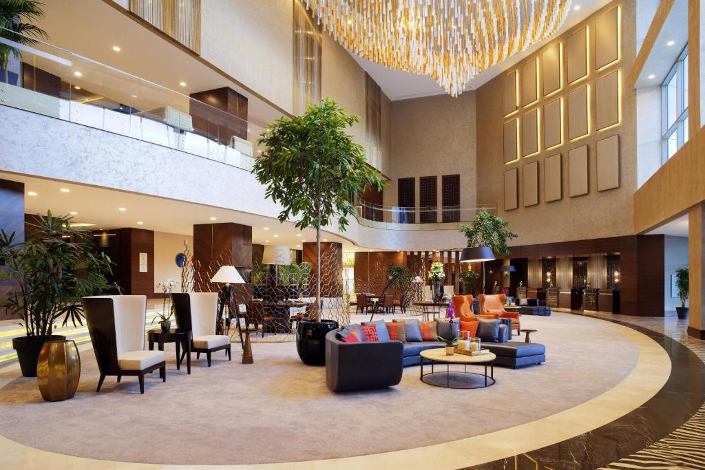 a hotel lobby with couches and chairs and a chandelier at Sheraton Grand Samsun Hotel in Samsun