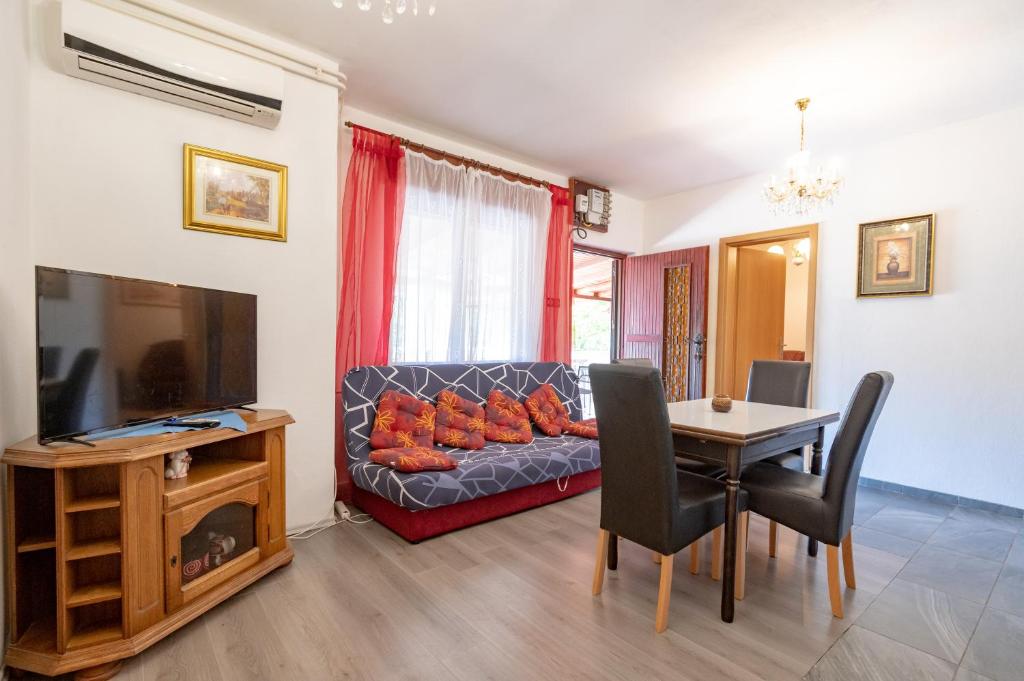 a living room with a couch and a table at Apartments Ruža Dragove Dugi otok in Dragove