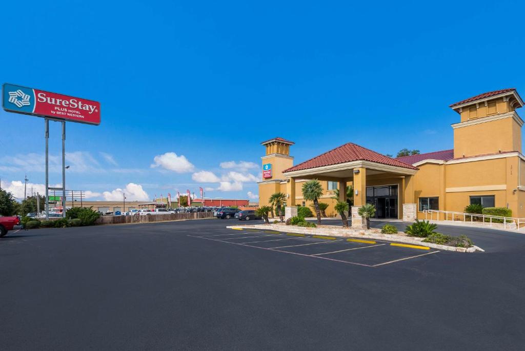 a front view of a hotel with a parking lot at SureStay Plus Hotel by Best Western San Antonio North in San Antonio