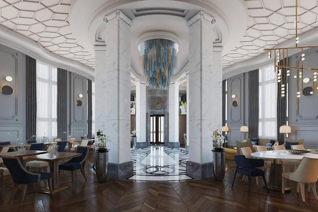 a restaurant with tables and chairs and a chandelier at Orientbank Hotel Istanbul, Autograph Collection in Istanbul