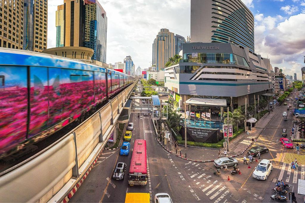 a city street with cars and a train on a building at The Westin Grande Sukhumvit, Bangkok in Bangkok