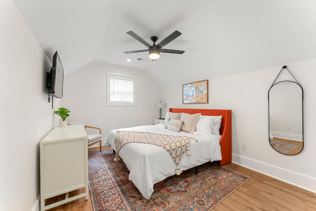a bedroom with a bed and a ceiling fan at Peaceful & Modern Historic Norcross Home in Norcross