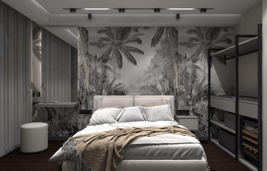 a bedroom with a bed with palm trees on the wall at Uzunkum Hotel in Trabzon