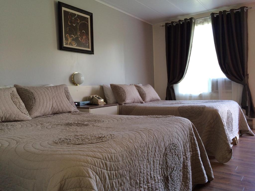Postel nebo postele na pokoji v ubytování Motel de la Pente Douce