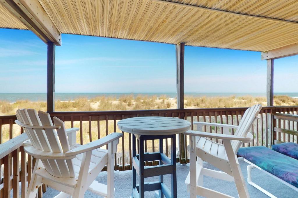 a porch with two chairs and a table and chairs at Windbreaker 5 in Ocean City